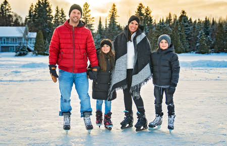 Happy family on ice skating on winter season lake