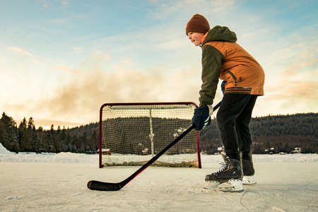 portrait of happy hockey player on a lakeの写真素材