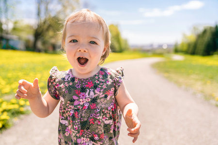 nice and Cute baby girl walking outdoorsの写真素材