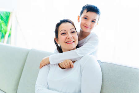 Mother with her son having fun in living room at home
