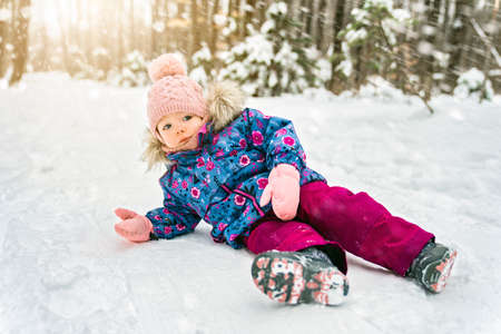 Adorable little baby girl having fun on winter dayの写真素材