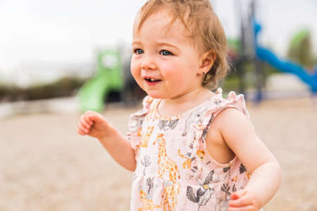 Cute baby girl playing on outdoor playgroundの写真素材