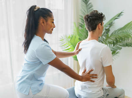 black rehabilitation woman physiotherapy at physio clinic with customer