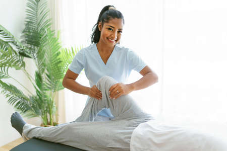 black rehabilitation woman physiotherapy at physio clinic with customer check the knee