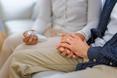 hand holding tissue of a couple sit on sofa