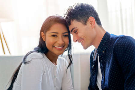 european couple in living room having fun on the sofa
