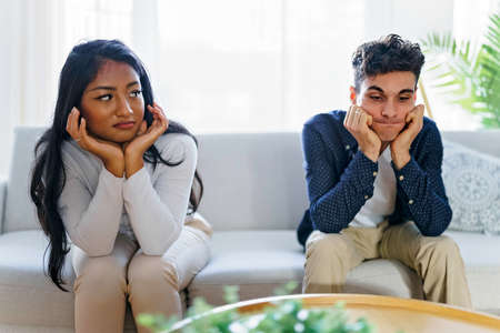 Man being mad at his girlfriend in their living roomの写真素材