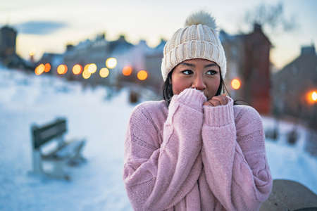Portrait of a beautiful young model outside in winter season with hat look like frozenの写真素材