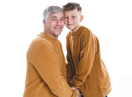 Father and son having fun together on studio white
