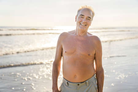 Senior men having great time on beach at the sunset