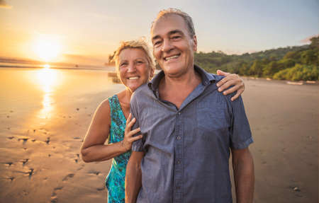 Senior Couple Enjoying Beautiful Sunset on the Beach
