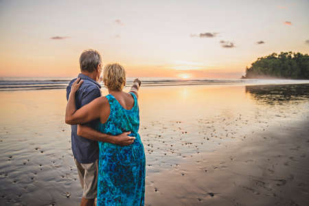 Senior Couple Enjoying Beautiful Sunset on the Beach