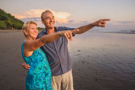 Senior Couple Enjoying Beautiful Sunset on the Beach