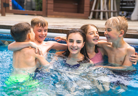 group of children having fun in Pool on the summer timeの写真素材