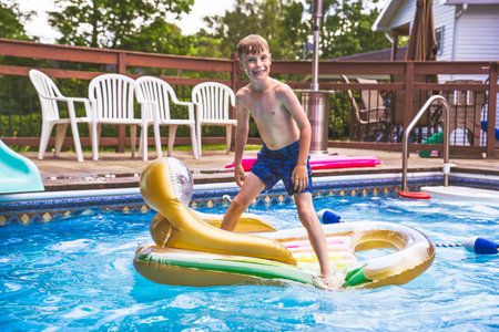 child boy having fun in Pool on the summer time