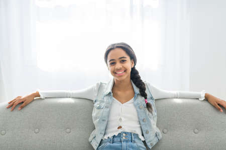 African Teen Girl Sit On Couch At Home