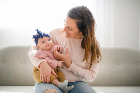 Mother with her baby son on sofa