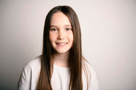 Young brunette pre teen girl on studio whiteの写真素材