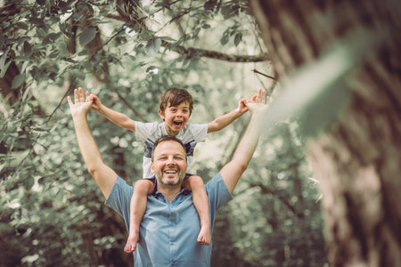 father with his little boy playing with him in nature.の写真素材