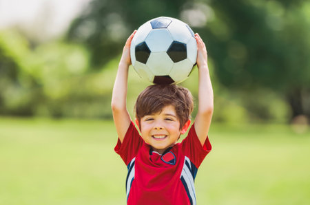 Young soccer player having fun on a field with ballの写真素材