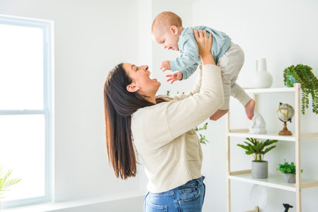 mother enjoying time with her adorable toddler son at homeの写真素材