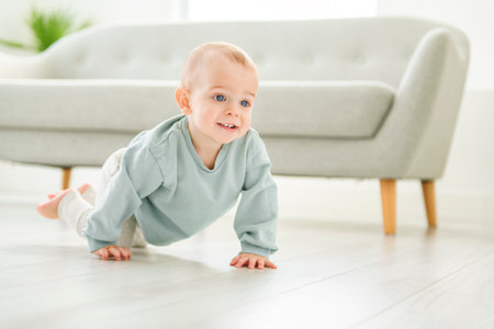 Happy toddler boy crawling in sitting room