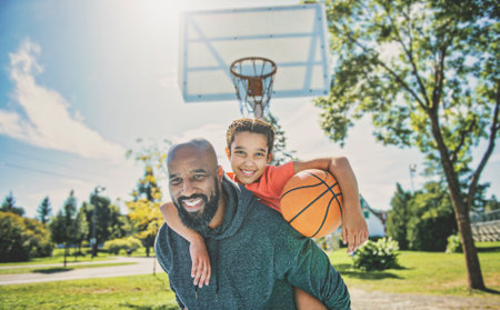 father and daughter playing basketball in the parkの写真素材