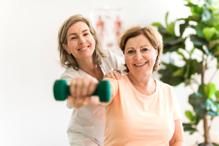 Physiotherapist working with elderly patient in clinicの写真素材