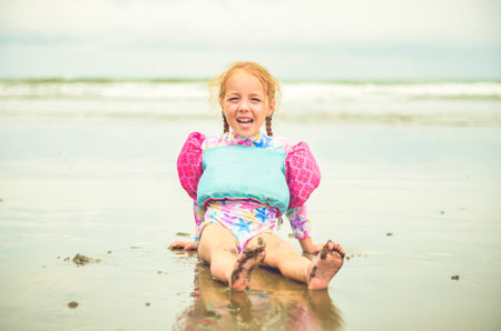 child girl of 4 years sit on beach of Costa Ricaの写真素材