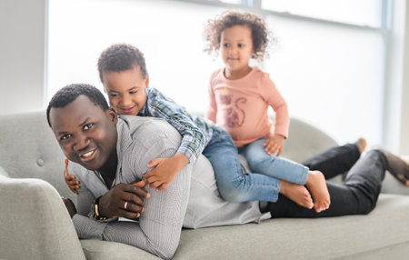 American father with little boy and girl at homeの写真素材