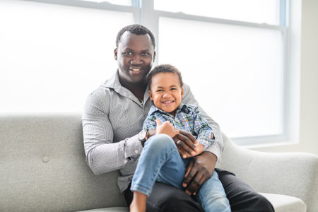 Happy Black American father with little boy at homeの写真素材