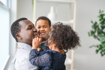 American father with little boy and girl at homeの写真素材