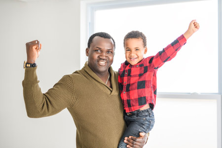 Happy Black American father with little boy at homeの写真素材