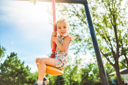 Happy 3 years old girl on a playgroundの写真素材