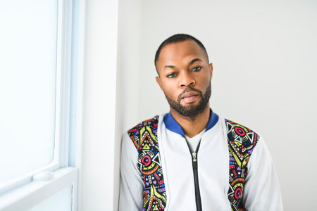 young adult american man standing at home background with fashion clothes