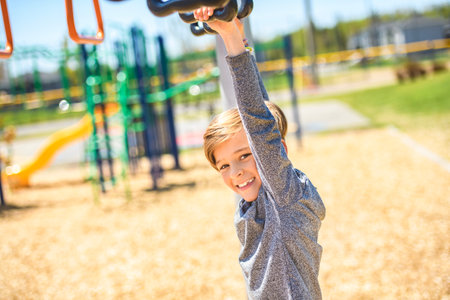 child boy on a playground on summer day.の写真素材