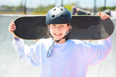 child girl playing skate or skateboard at parking to wearing safety helmetの写真素材