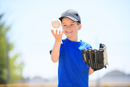 Young boy play baseball on summer dayの写真素材