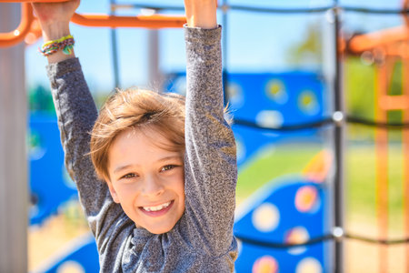 child boy on a playground on summer day.の写真素材