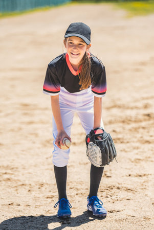 Young girl play baseball on summer dayの写真素材