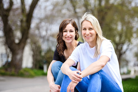Two beautiful girls together in a parkの写真素材