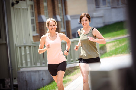 Two Females Runner Jogging Outdoor Workout togetherの写真素材