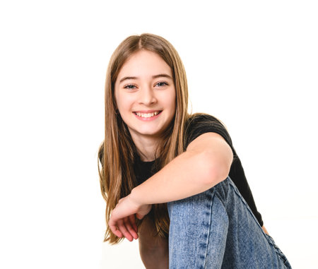 Young brunette pre teen girl on studio whiteの写真素材