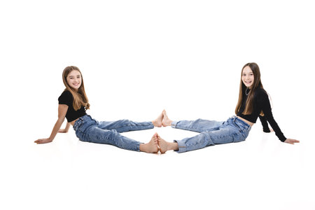 Two Young pre teen best friend girl on studio whiteの写真素材