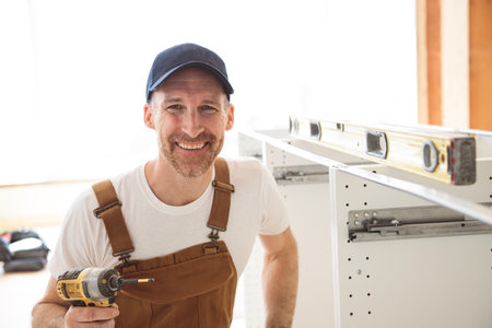 Carpenter Installing Luxury Modern Fitted Kitchen in house