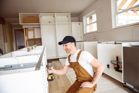 Carpenter Installing Luxury Modern Fitted Kitchen in houseの写真素材