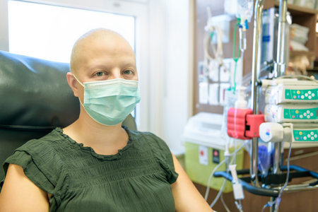 Young woman in hospital bed suffering from breast cancer receiving treatment
