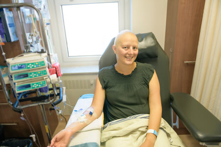 Young woman in hospital bed suffering from breast cancer receiving treatmentの写真素材