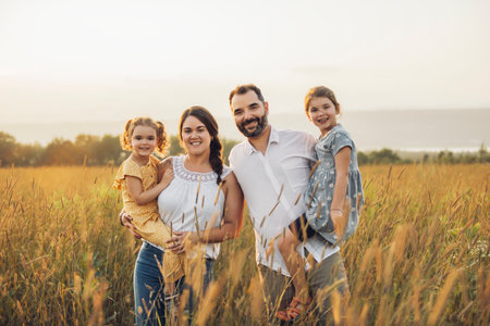 Happy family mother father and children daughter on nature sunset