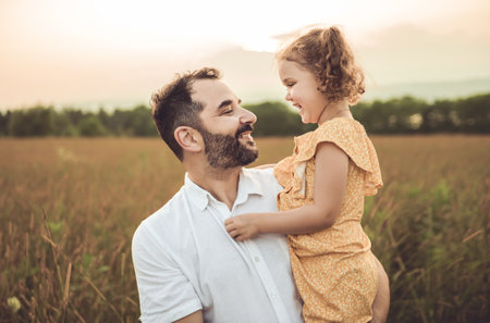 Happy family father with children daughter on nature sunsetの写真素材